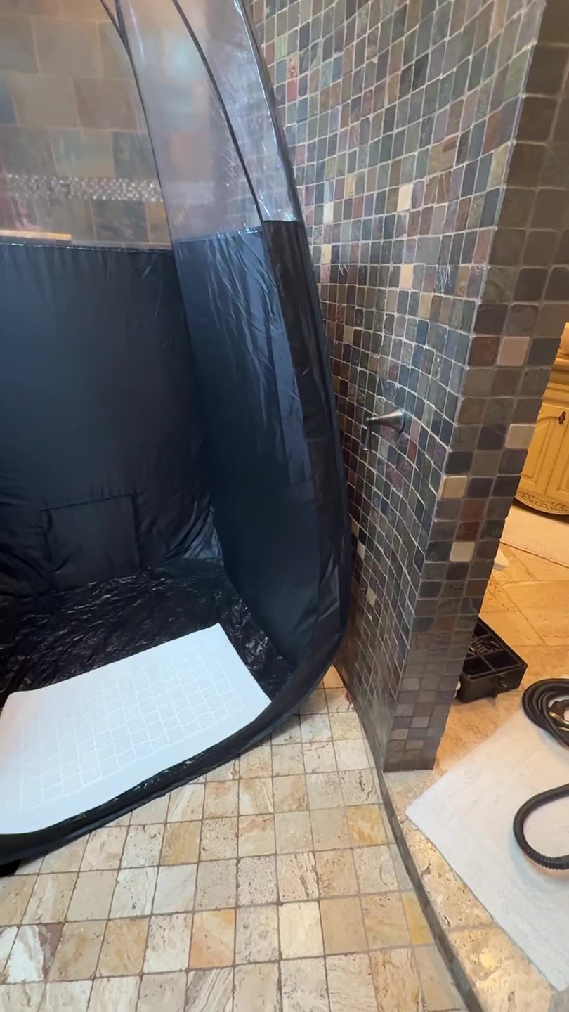Mobile spray tan tent set up beside a client's walk-in shower — The Bronze Lily, St. Petersburg, FL